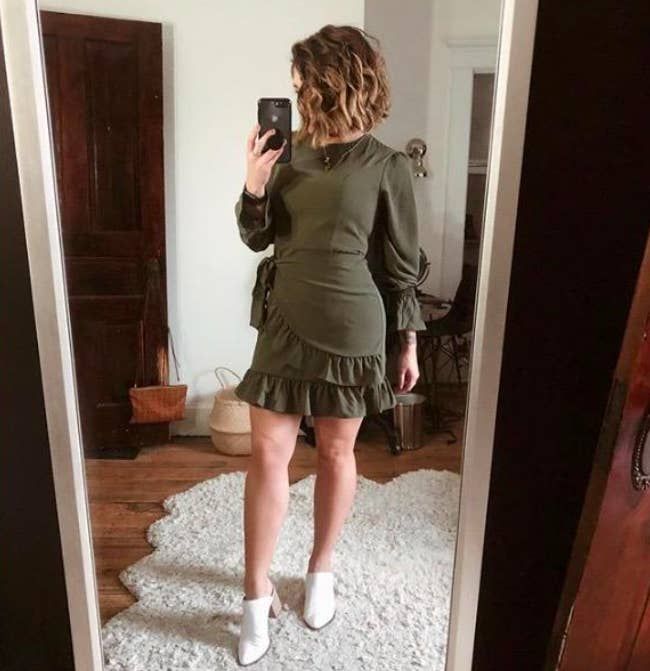 A customer review photo of them wearing the army green dress