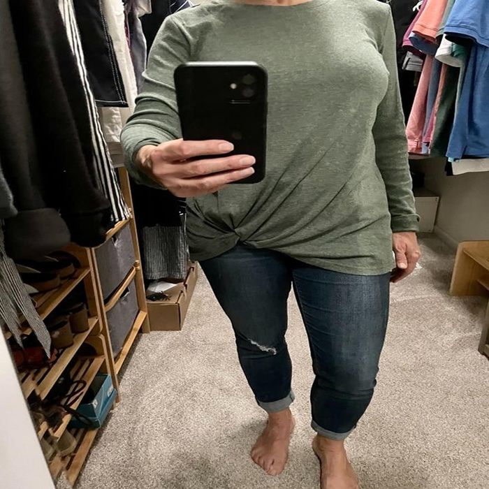 An Amazon reviewer is wearing a green twist-knot tunic.
