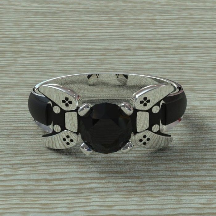 An alternate view of the ring, showcasing the controller accents on either side of the center stone