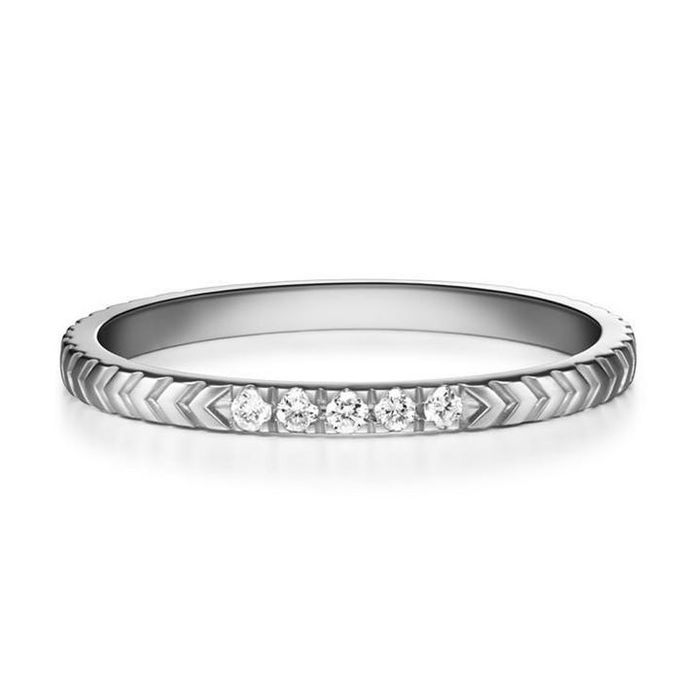 A detailed closeup of the silver ring featuring a geometric motif and five dazzling diamonds