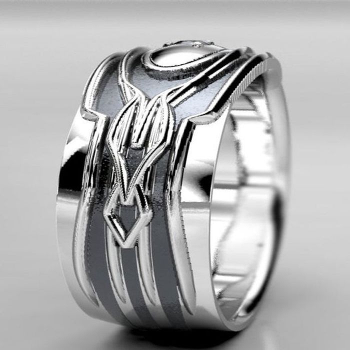 A side view of the ring highlighting the detailed geometric engravings along the band