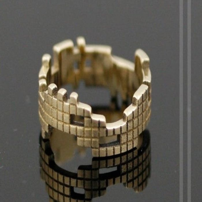 A uniquely designed gold band featuring engraved Tetris block shapes in various forms