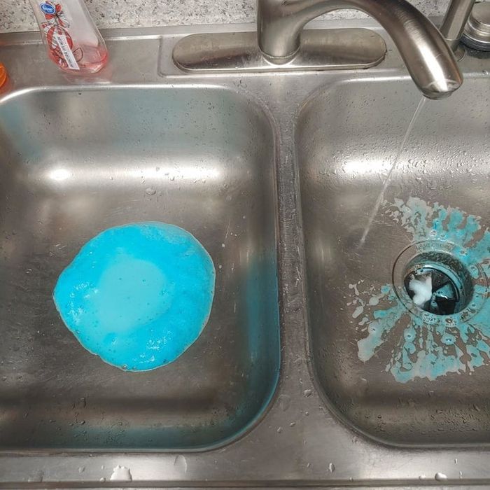 A reviewer shows the disposer cleaner actively bubbling up through the drains in their kitchen sink, working its magic to eliminate grime.