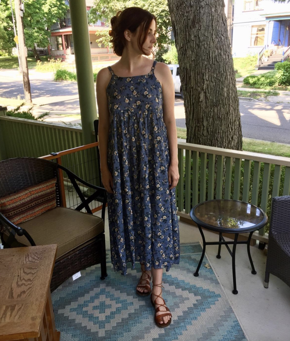 The reviewer is wearing a long blue dress.
