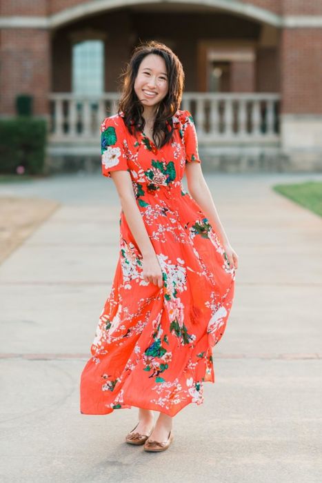 A reviewer wearing a short-sleeve button-up dress