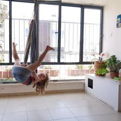 A different child model using the chair as a jungle gym swing.