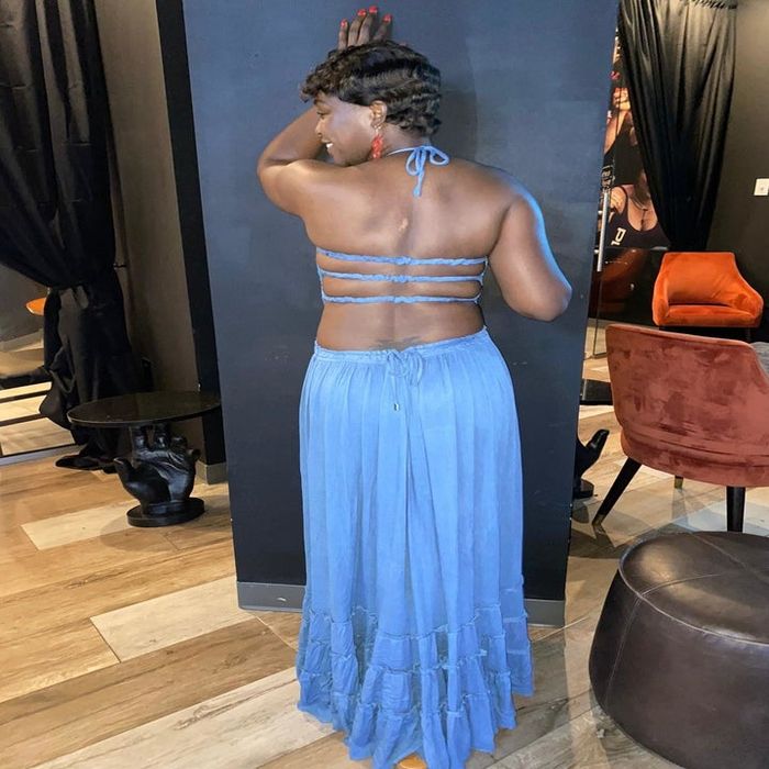 Reviewer showing off the back of the blue dress