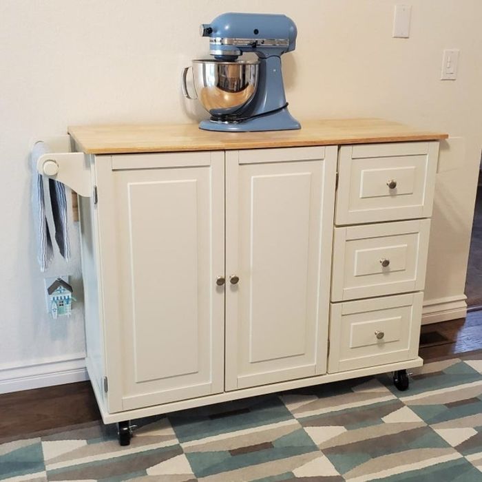 The kitchen island up close with an electric mixer on top