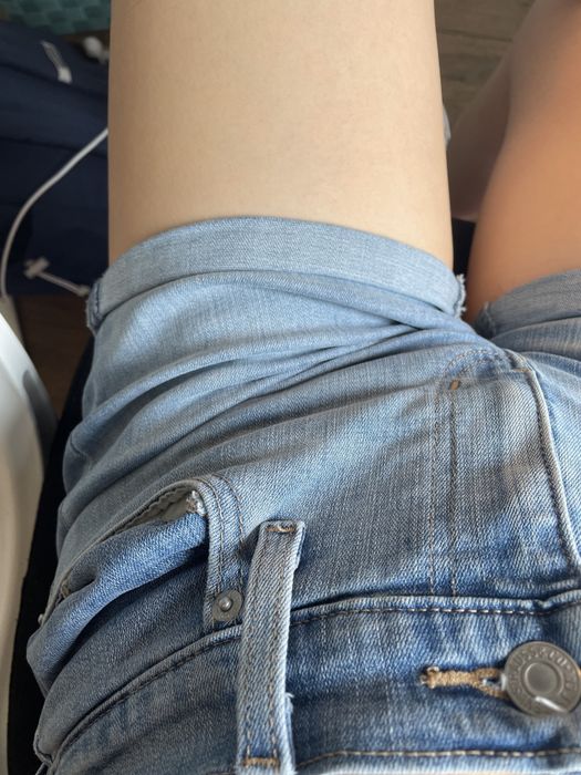 A close-up photo showing the buttons and the pocket details of the shorts