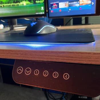 a close-up photo of the buttons used to adjust the desk height