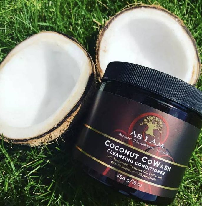 A jar of cleansing conditioner paired with a halved coconut
