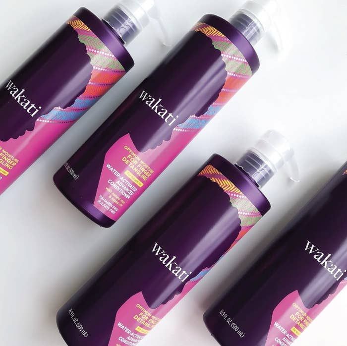 A collection of purple bottles filled with hair conditioner