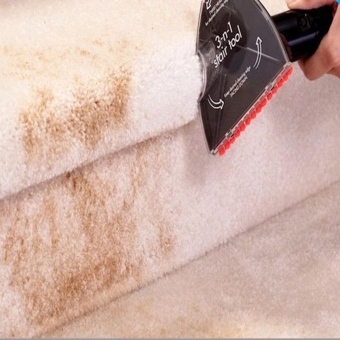 an individual utilizing the Bissell stair cleaning attachment