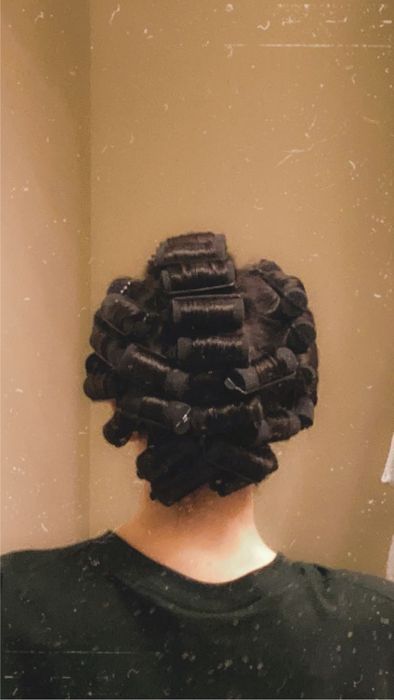 A reviewer with the curlers in their hair