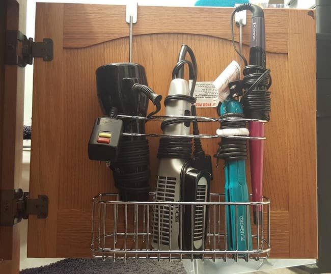 The silver organizer holding four hot tools in a reviewer's bathroom.