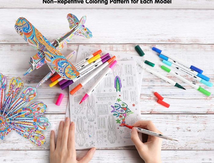 A model’s hands carefully coloring intricate pieces of a 3D puzzle