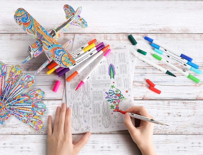 A model’s hands carefully coloring intricate pieces of a 3D puzzle