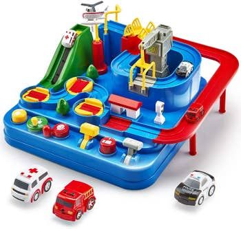 The race track placed alongside a toy ambulance, firetruck, and police car