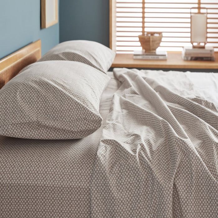 The geometric sheets spread across a bed