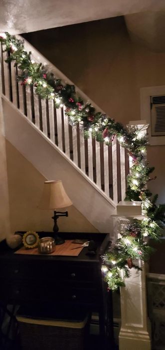 A reviewer’s photo of the glowing garland lining their staircase at night