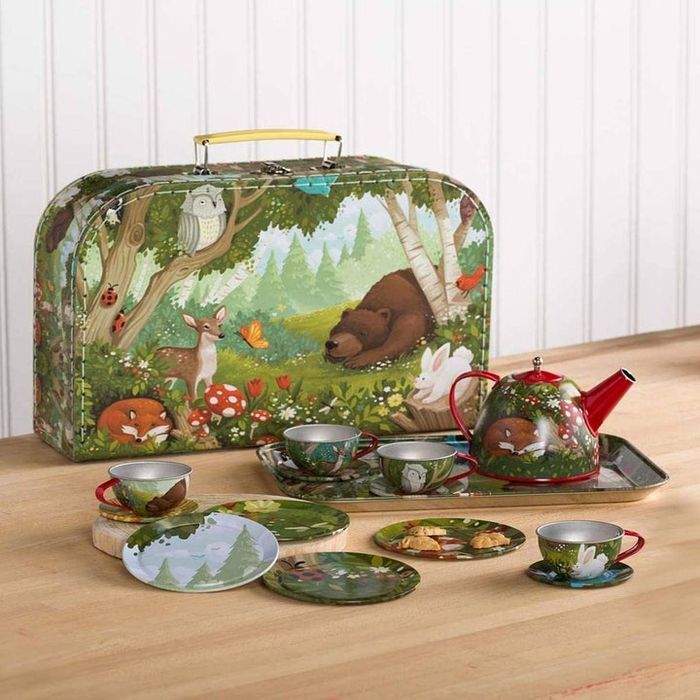 A forest-themed tin tea set, complete with a storage case, tray, teapot, and multiple cups and dishes