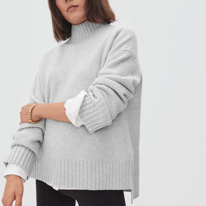Model wearing a soft gray sweater