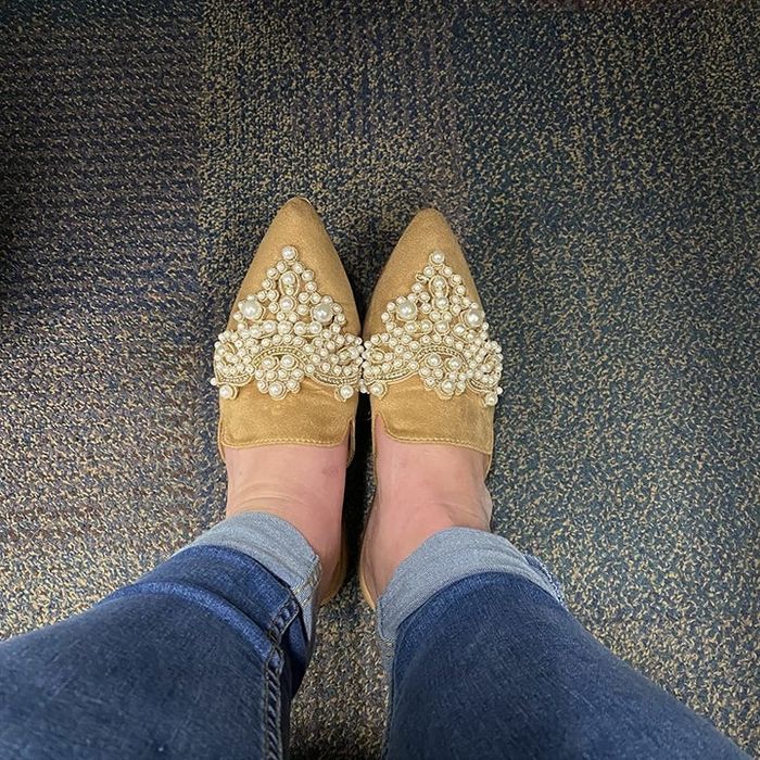 A reviewer pairs these faux suede mules, adorned with jewel details, for a chic look.