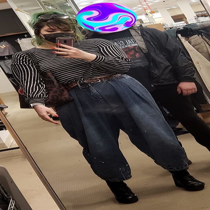 A reviewer wearing the product with a belt.