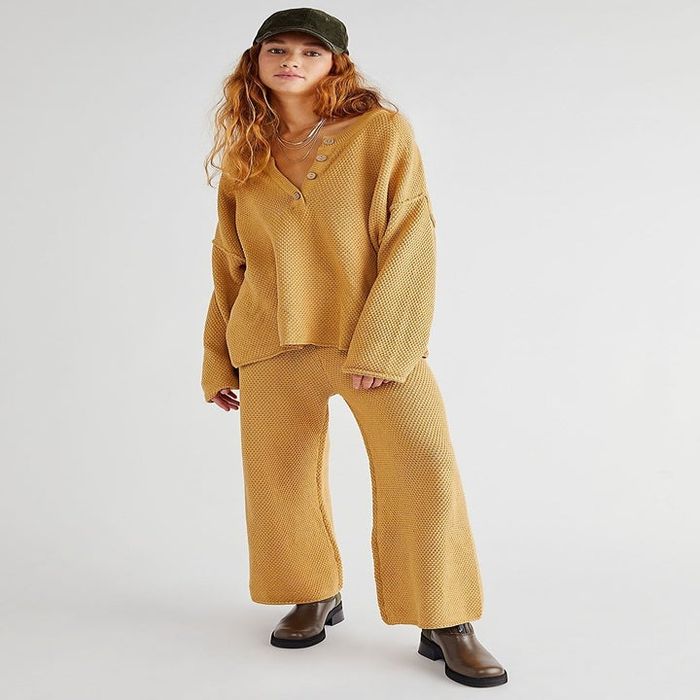 Model wearing a mustard-colored sweater set
