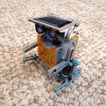 The reviewer showcasing a side view of the robot they constructed, displaying its mechanical features.