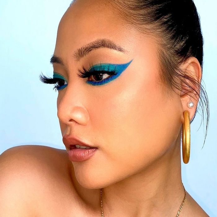 a model showcasing blue and green eye makeup