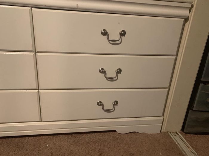 A photo shows the same dresser, now free of any scribbles after cleaning.