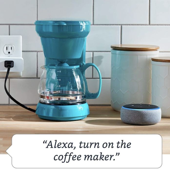 A smart plug connected to a kitchen coffee maker, with a speech bubble that says,