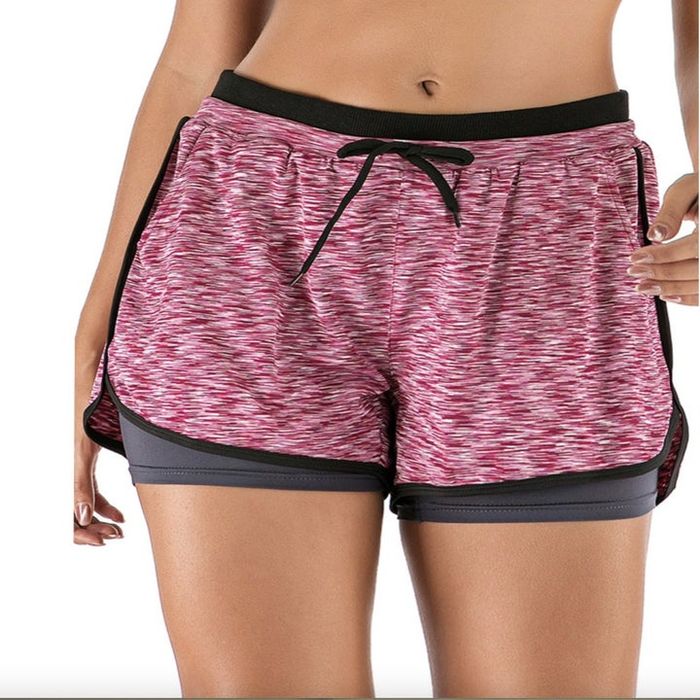 A person sporting yoga shorts with grey mini shorts layered underneath