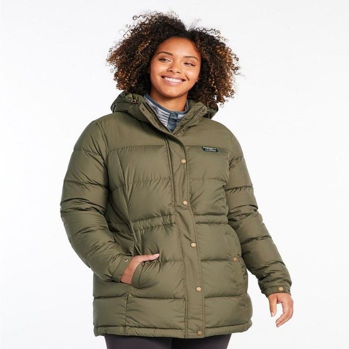 Model wearing a classic green down parka with their hand in their pocket