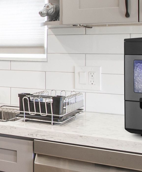An ice machine placed on a kitchen countertop.