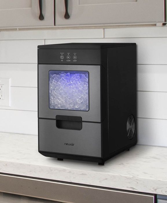 An ice machine placed on a kitchen countertop.