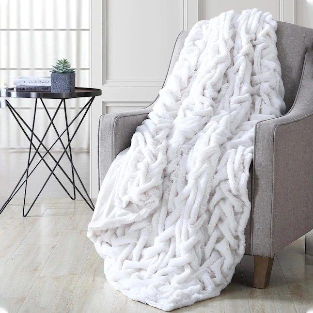 The throw blanket draped over a chair