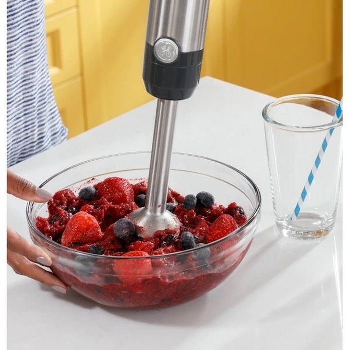 The immersion blender effortlessly blending fruit in a bowl