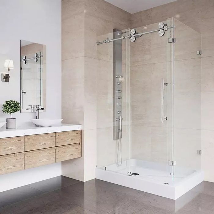 a frameless glass sliding shower door in a bathroom