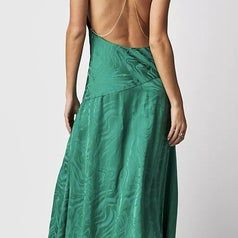 A back view of the model wearing the green dress
