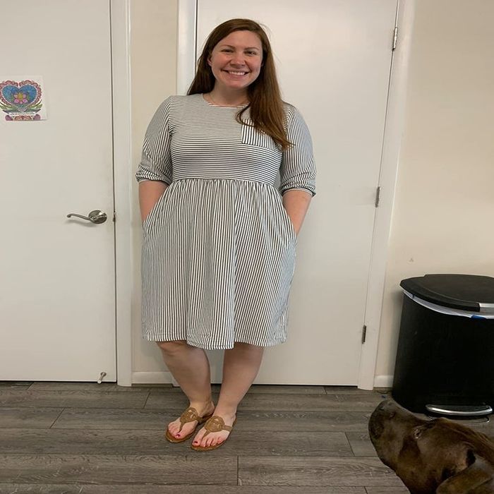 Reviewer wearing the striped dress paired with flip-flops