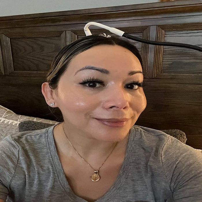 A reviewer applying the product to their face