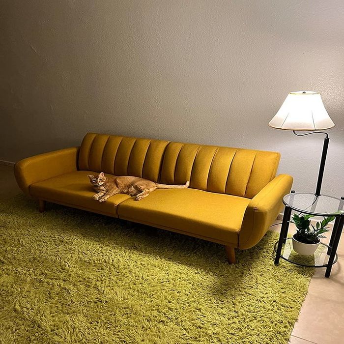 A reviewer’s photo showcasing the mustard yellow futon from a different angle