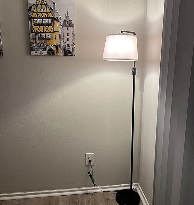 A reviewer’s photo of the floor lamp in a cozy living room setting