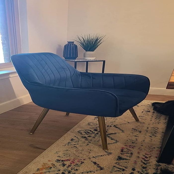 A reviewer’s photo of the navy blue chair, adding a pop of color to the room