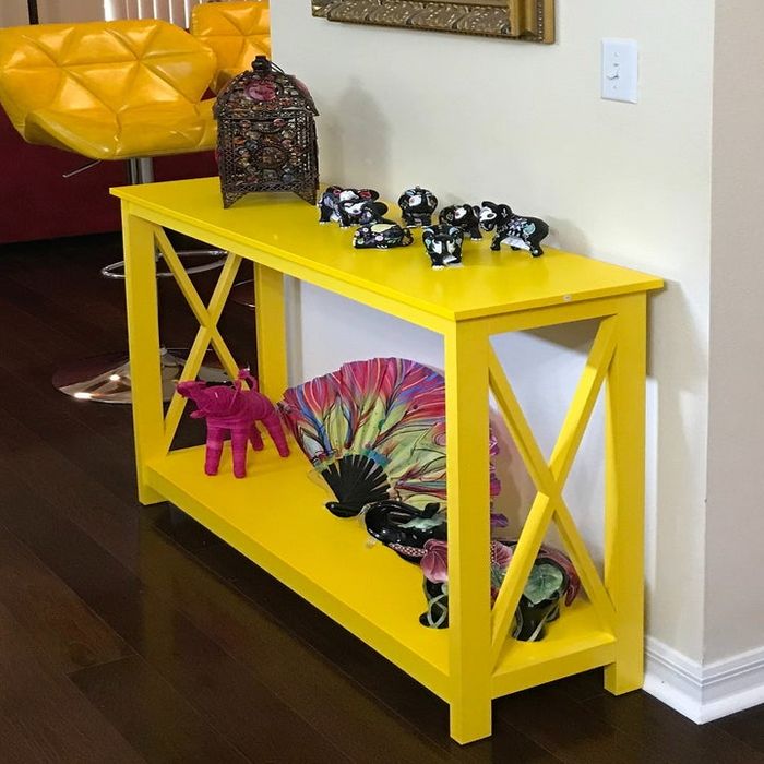 A reviewer’s photo featuring the vibrant yellow console table