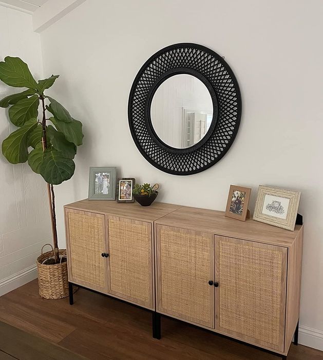 A reviewer’s photo of the sideboard placed beneath a mirror