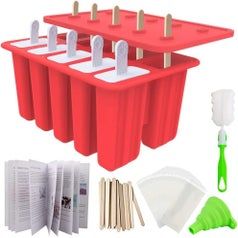 Full contents of the popsicle mold kit, including red molds, plastic and wooden sticks, and additional accessories