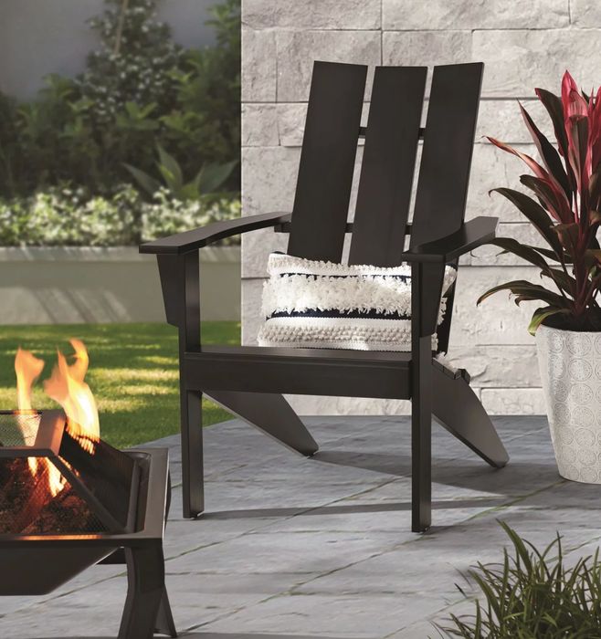 the black Adirondack chair placed in a well-styled patio environment